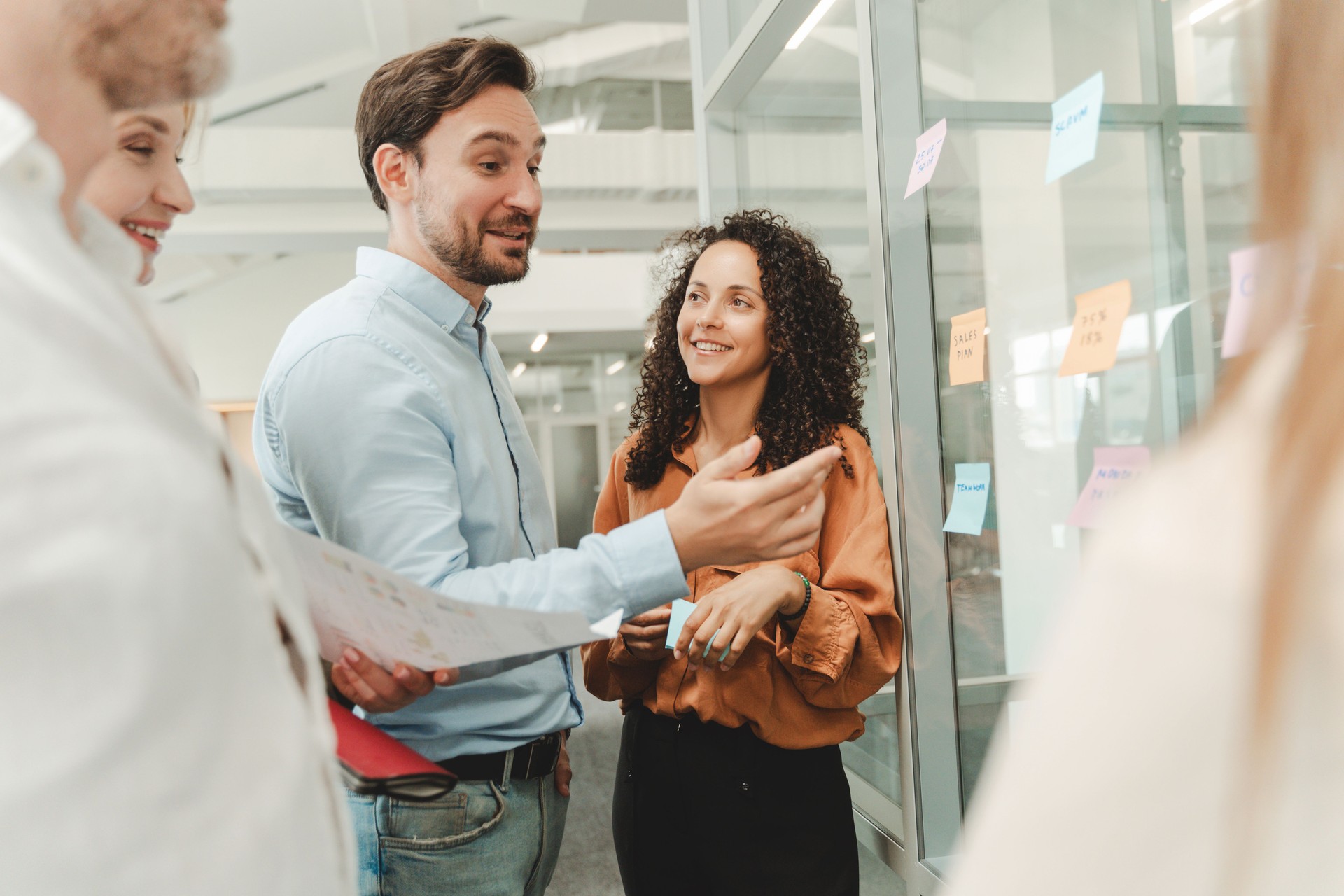 Businesspeople using sticky notes, agile methodology for productivity working in modern office
